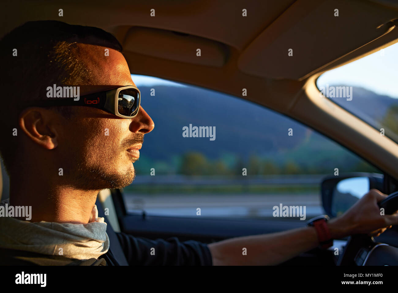 Man wearing sunglasses driving car hi-res stock photography and