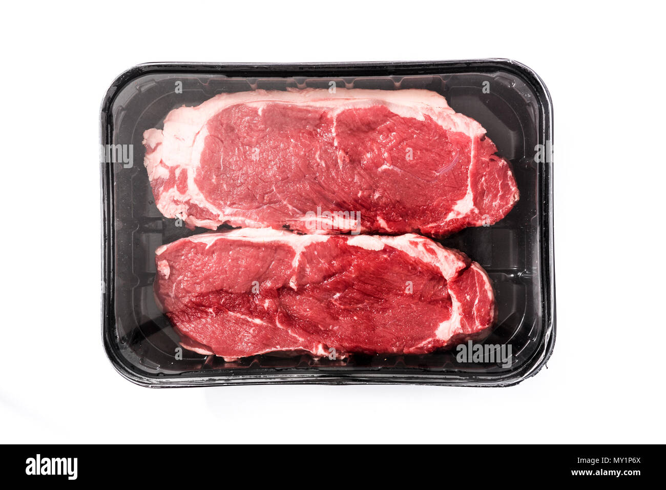 Packing raw beef steak isolated on white background. Top view Stock