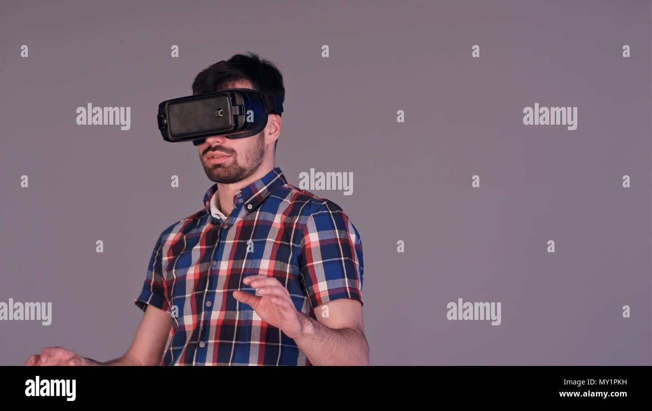 Young man working in virtual reality glasses Stock Photo