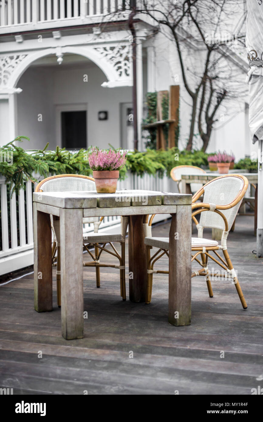 romantic delicate composition a chair and a table on the street Stock Photo