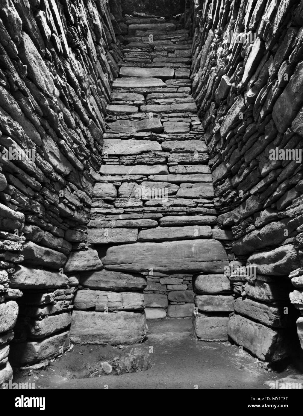 View S of the interior of Quoyness Neolithic chambered cairn, Sanday, Orkney, UK, showing entrances to 3 of the 6 burial cells off the main chamber. Stock Photo