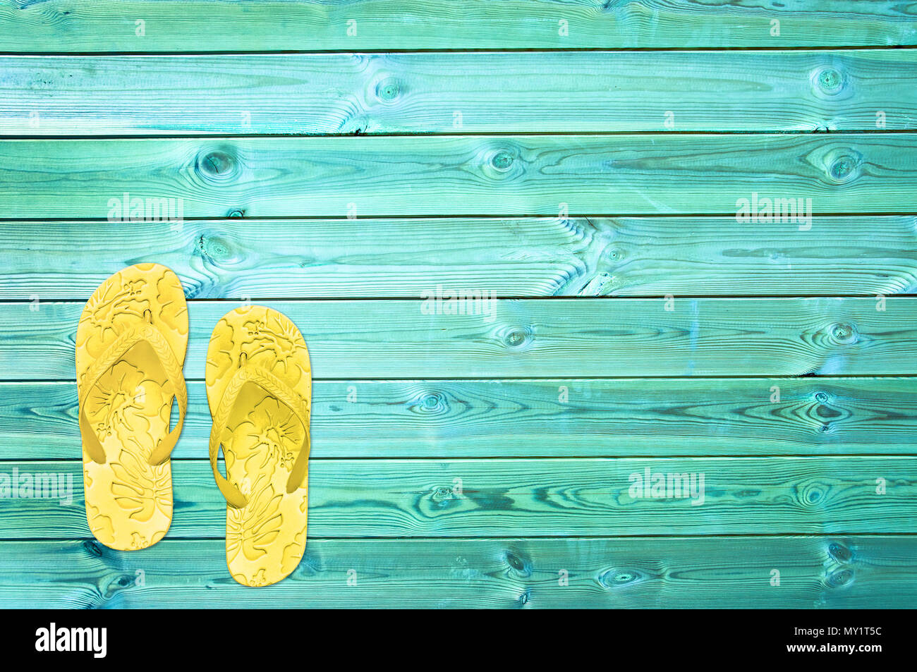 Yellow flip flops on blue planks, summer concept background with copy space Stock Photo