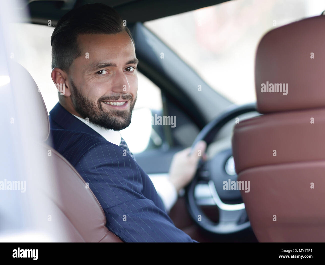 Businessman smiling behind car hi-res stock photography and images - Alamy