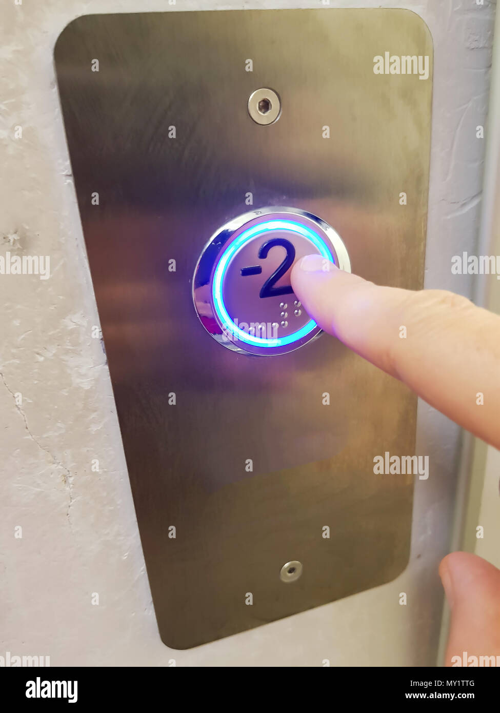 Finger about to presses the elevator button background, Elevator in a building pressing button Stock Photo