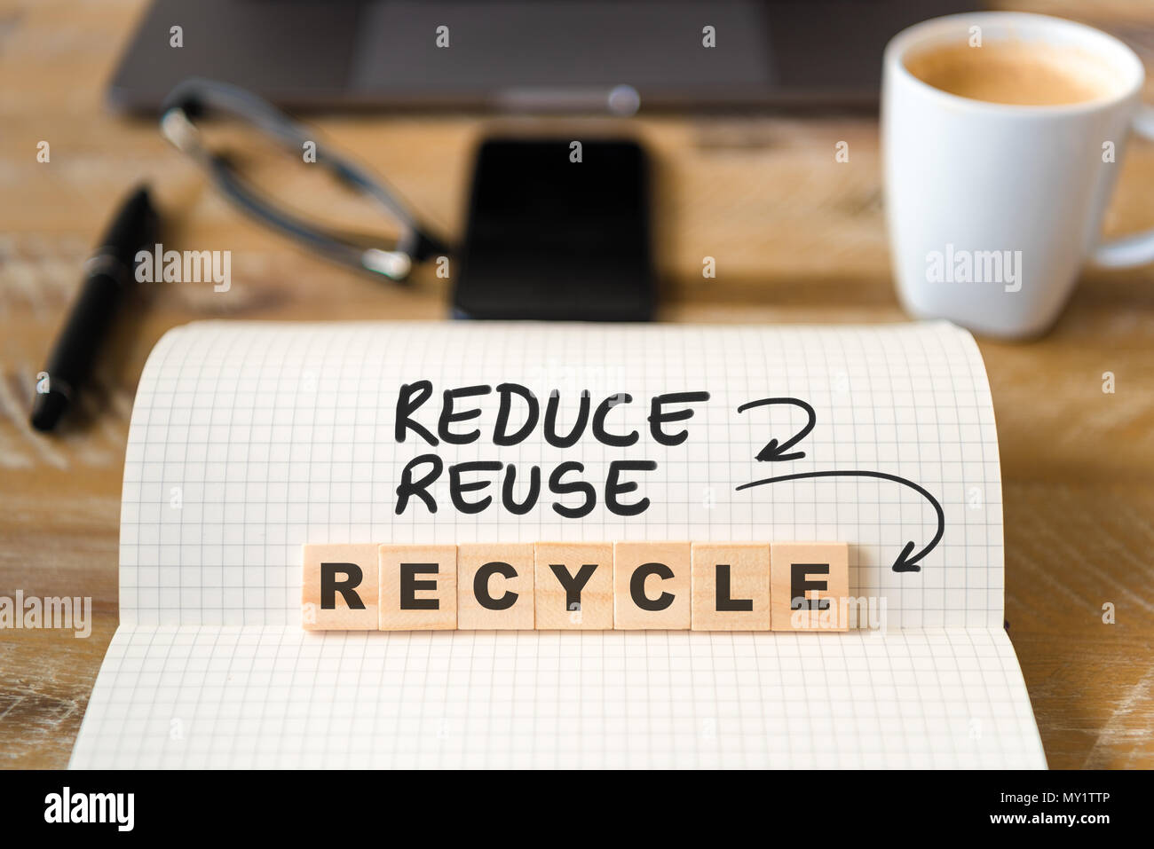 Closeup on notebook over wood table background, focus on wooden blocks ...