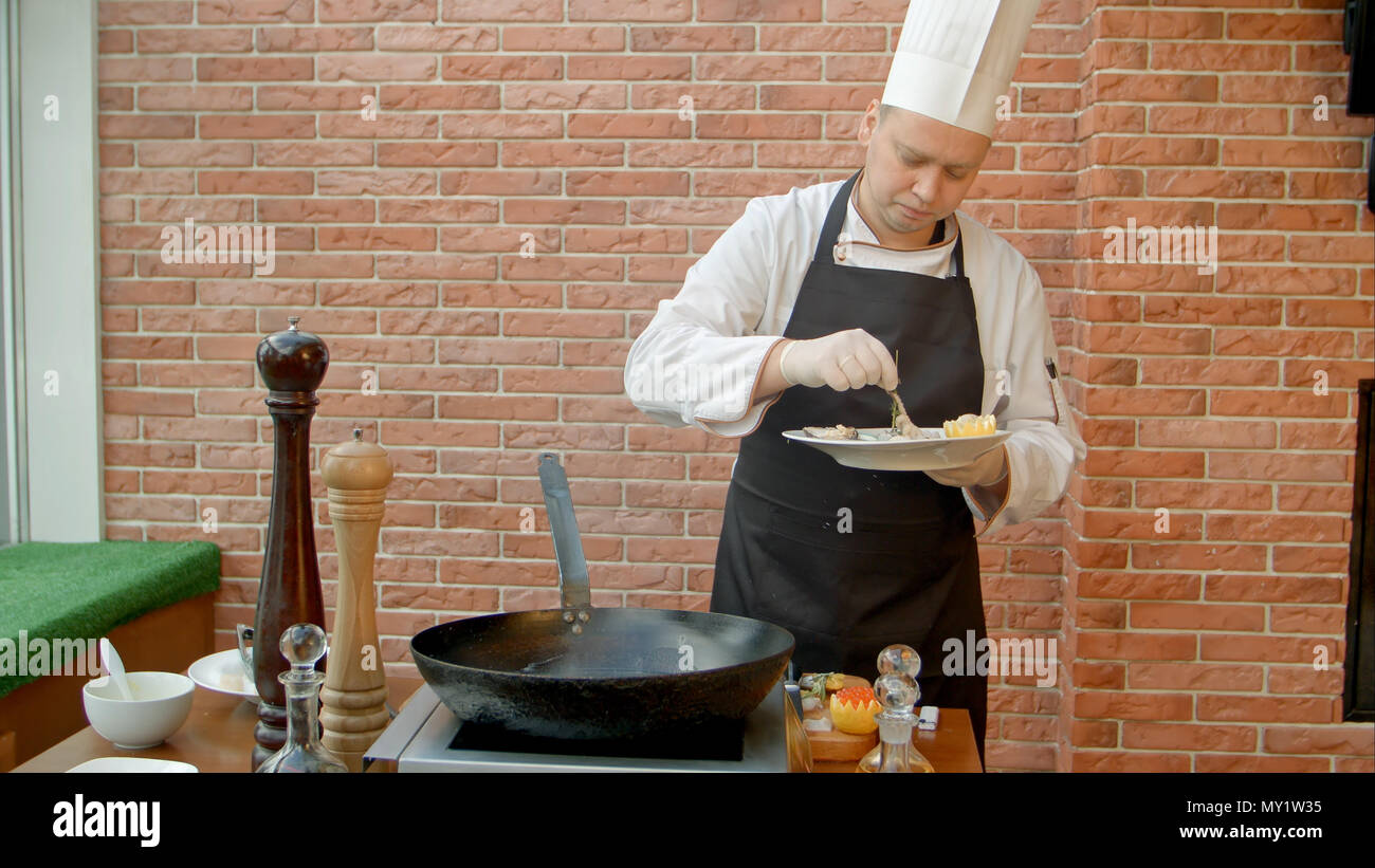 Professional chef cooking seafood in pan Stock Photo - Alamy