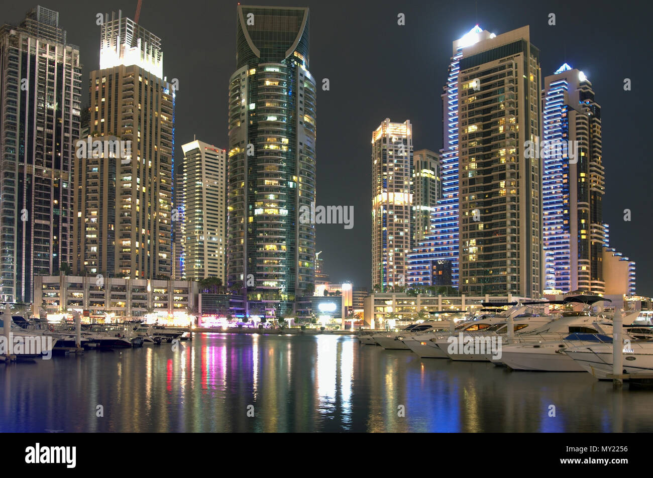 Dubai, United Arab Emirates - May  26, 2018.  High skyscrapers of the business city centers, located near the seaport.  Night time urban landscape Stock Photo