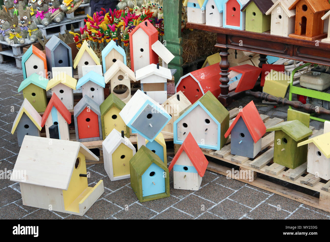 Handmade and homemade painted birdhouses and feeders are sold on the street during the fair