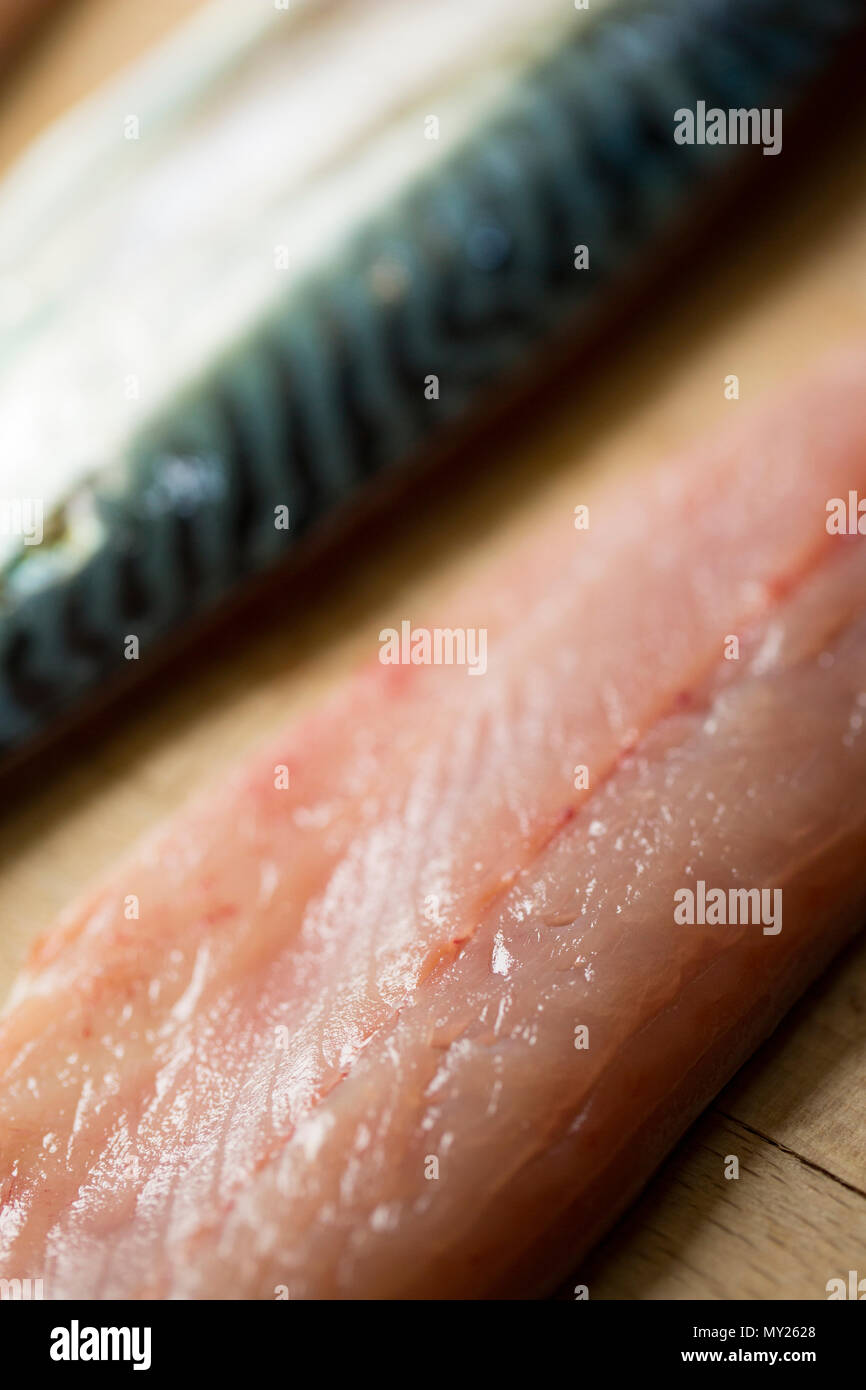 Raw mackerel fillets on a wooden chopping board from mackerel caught