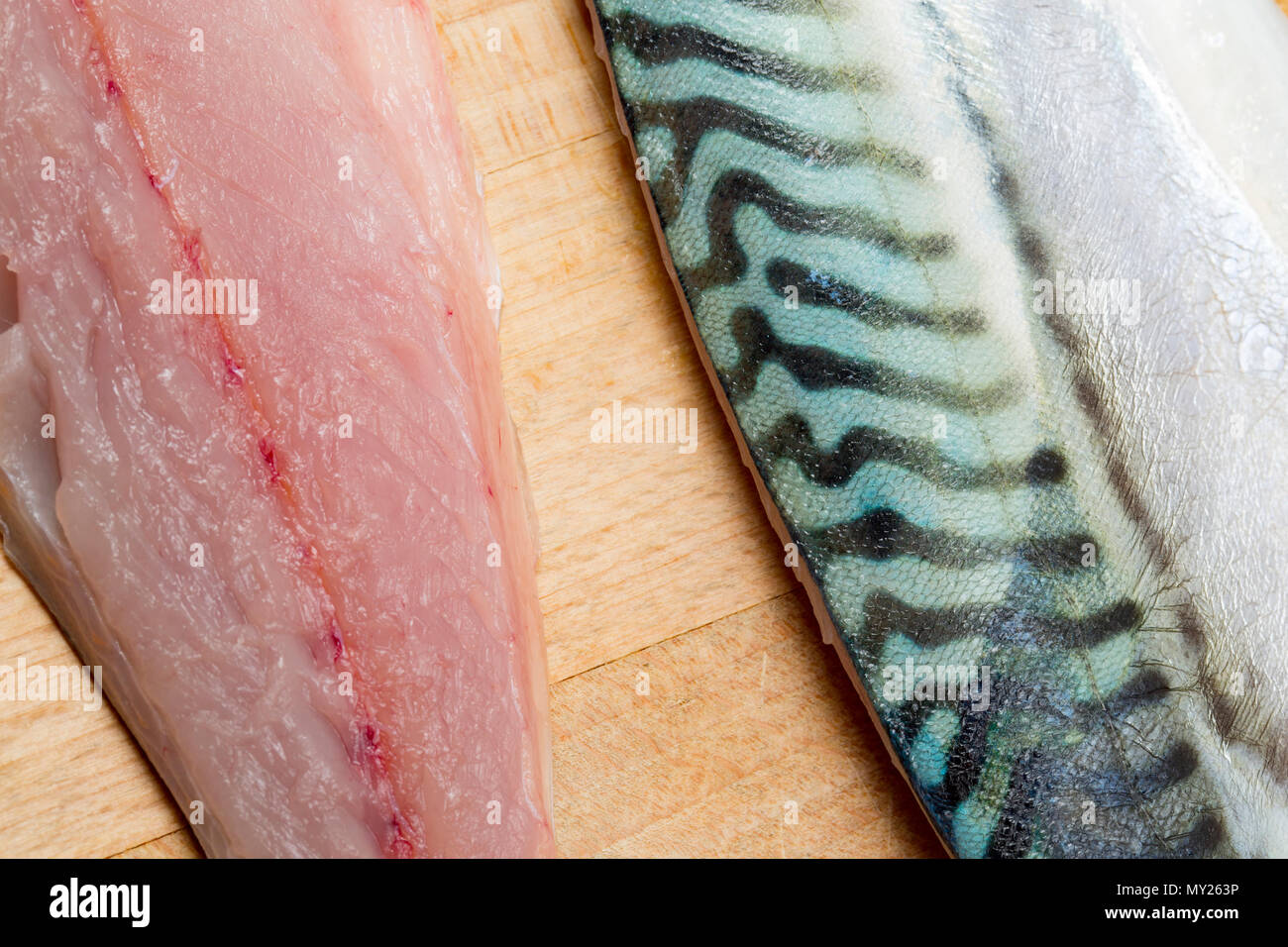 Raw mackerel fillets on a wooden chopping board from mackerel caught