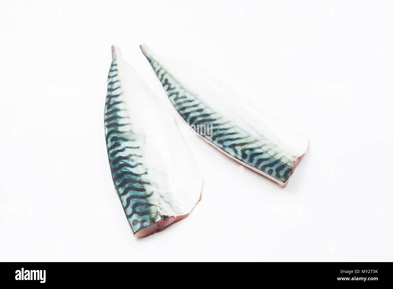 A pair of fresh, raw mackerel fillets on a white background from a mackerel caught from Chesil beach in Dorset on rod and line. Picture shows them ski Stock Photo