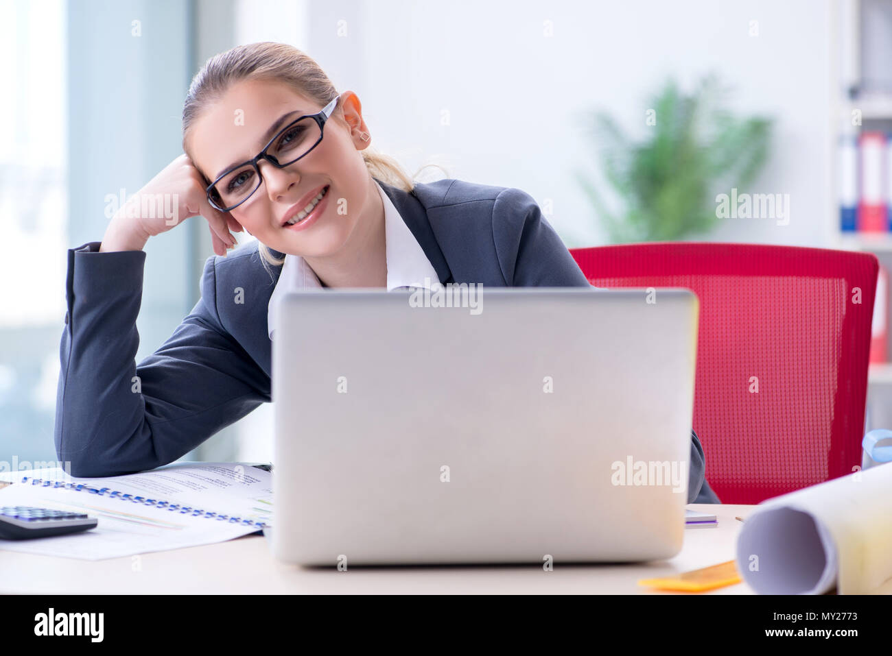 Businesswoman working at her desk in office Stock Photo - Alamy