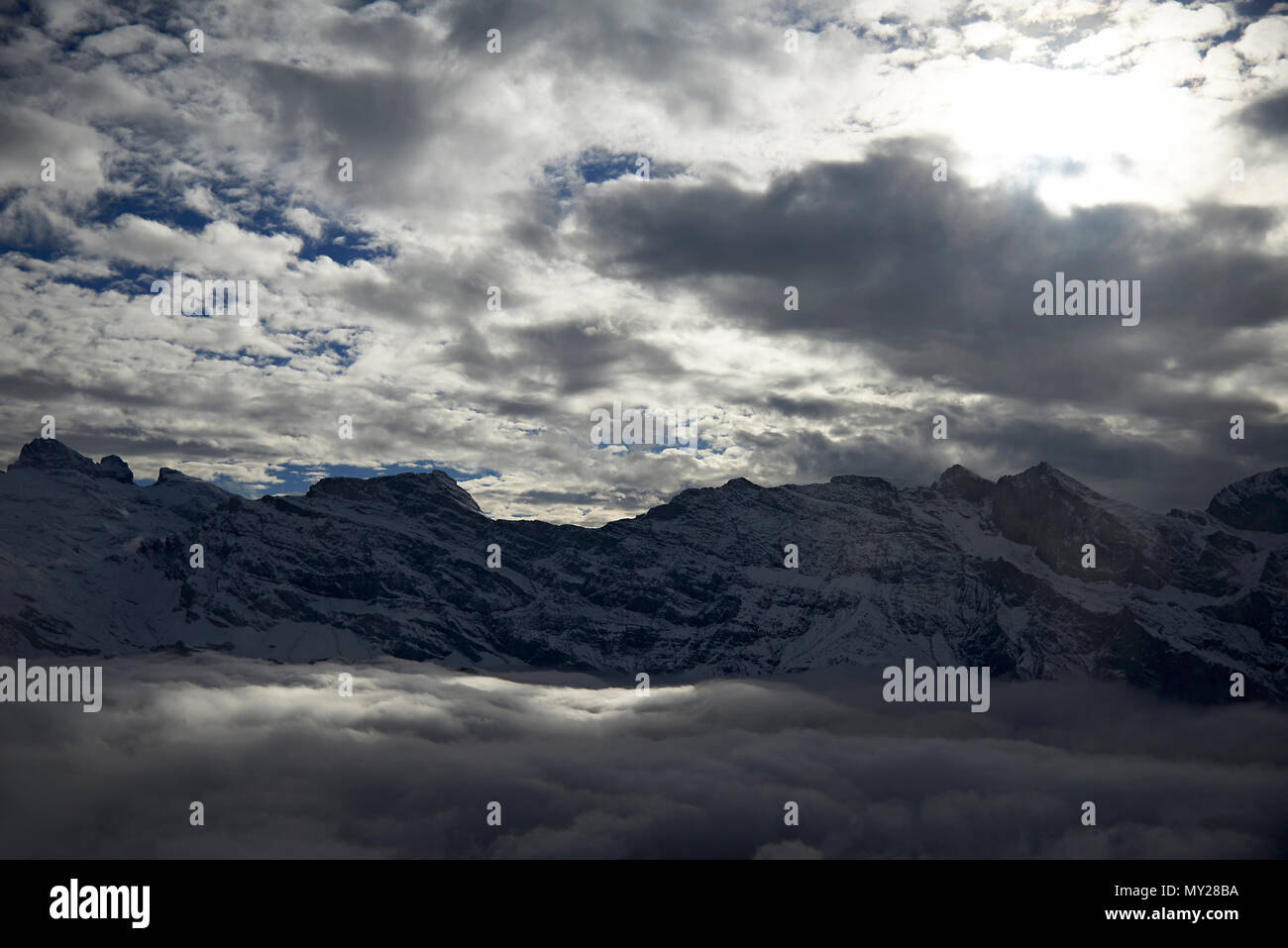 Stunning landscape showing the peaks of the high mountains in the Swiss Alps with the first signs of snow on the mountain tops. Stock Photo