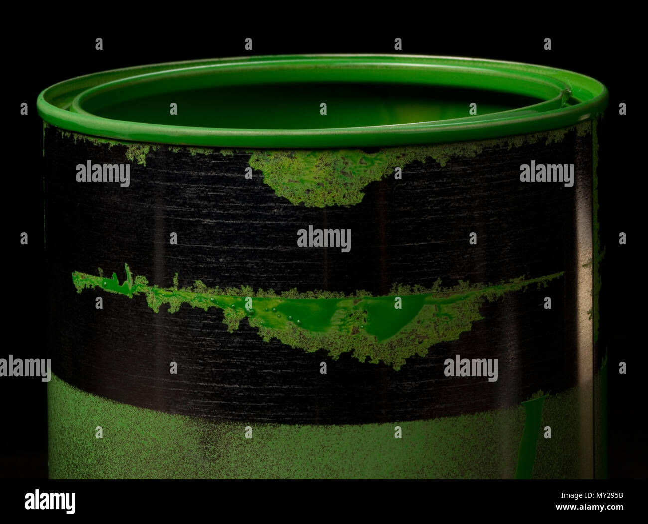 Colorful paint leaking down on wall of metal bucket. Isolated over