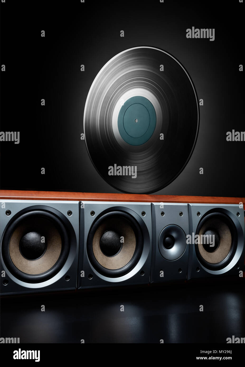 Vintage record (LP) rolling over a loudspeaker. Concept of music, party ...