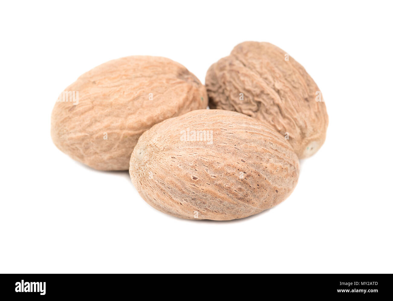 Three dry nutmeg isolated on white background Stock Photo