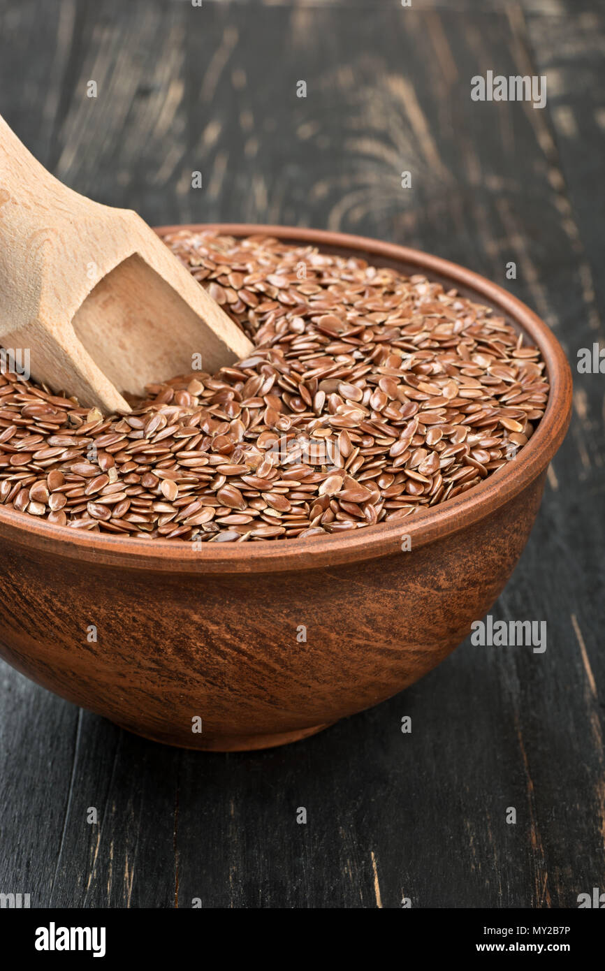 Flax seeds in bowl with scoop on the table closeup Stock Photo