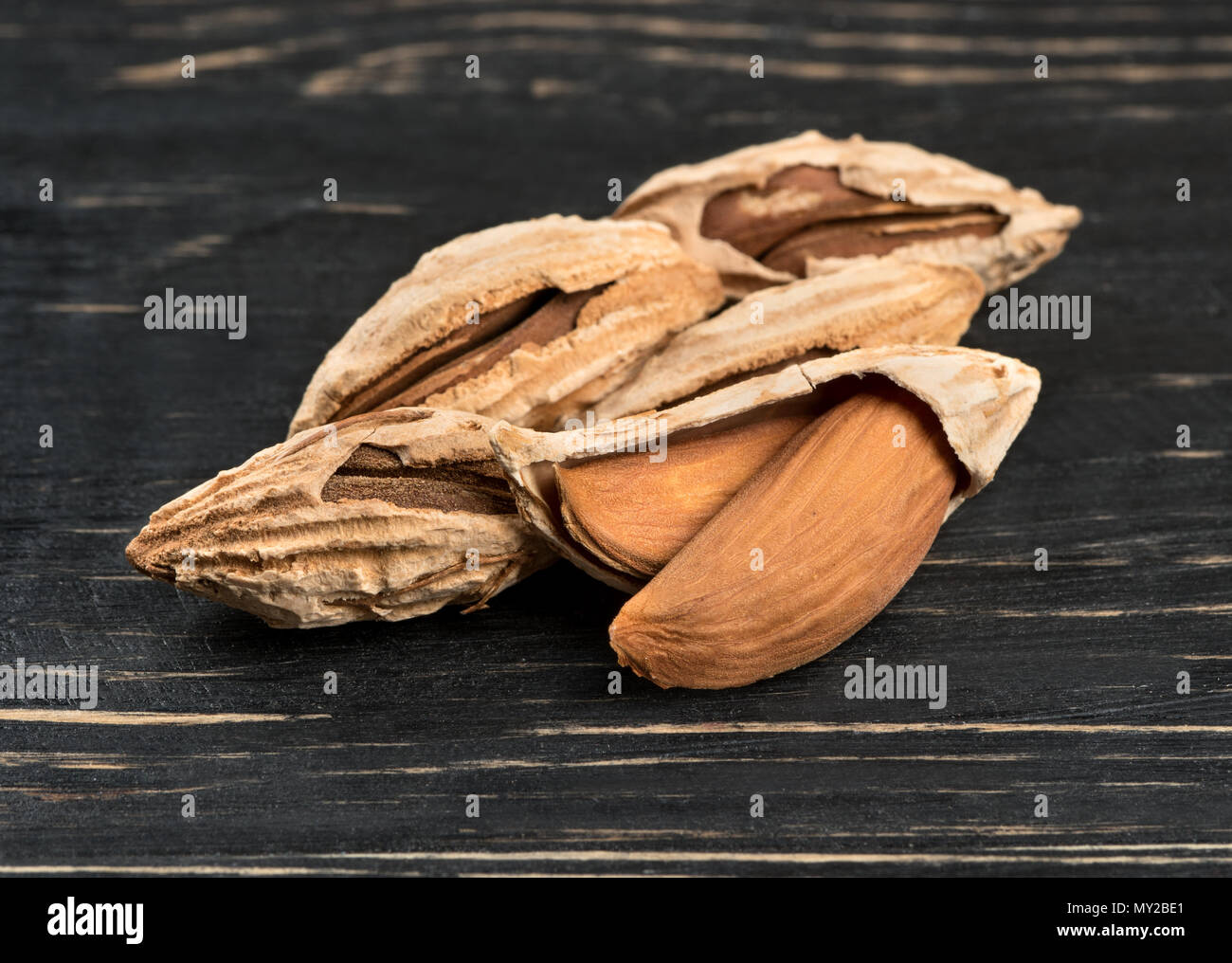 Wild uzbek inshell almonds on wooden background Stock Photo - Alamy