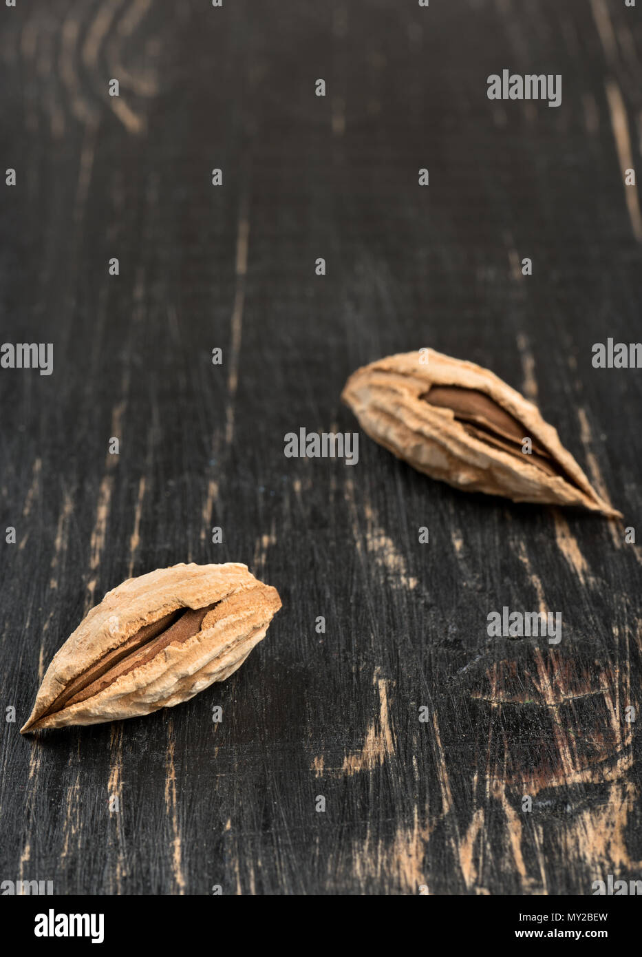 Two wild uzbek inshell almonds on an empty wooden background Stock ...