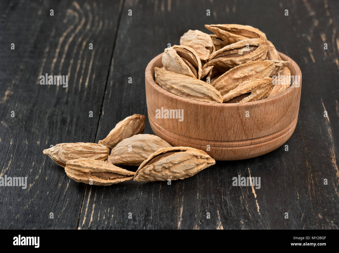 Wild uzbek inshell almonds in a bowl on wooden background Stock Photo ...