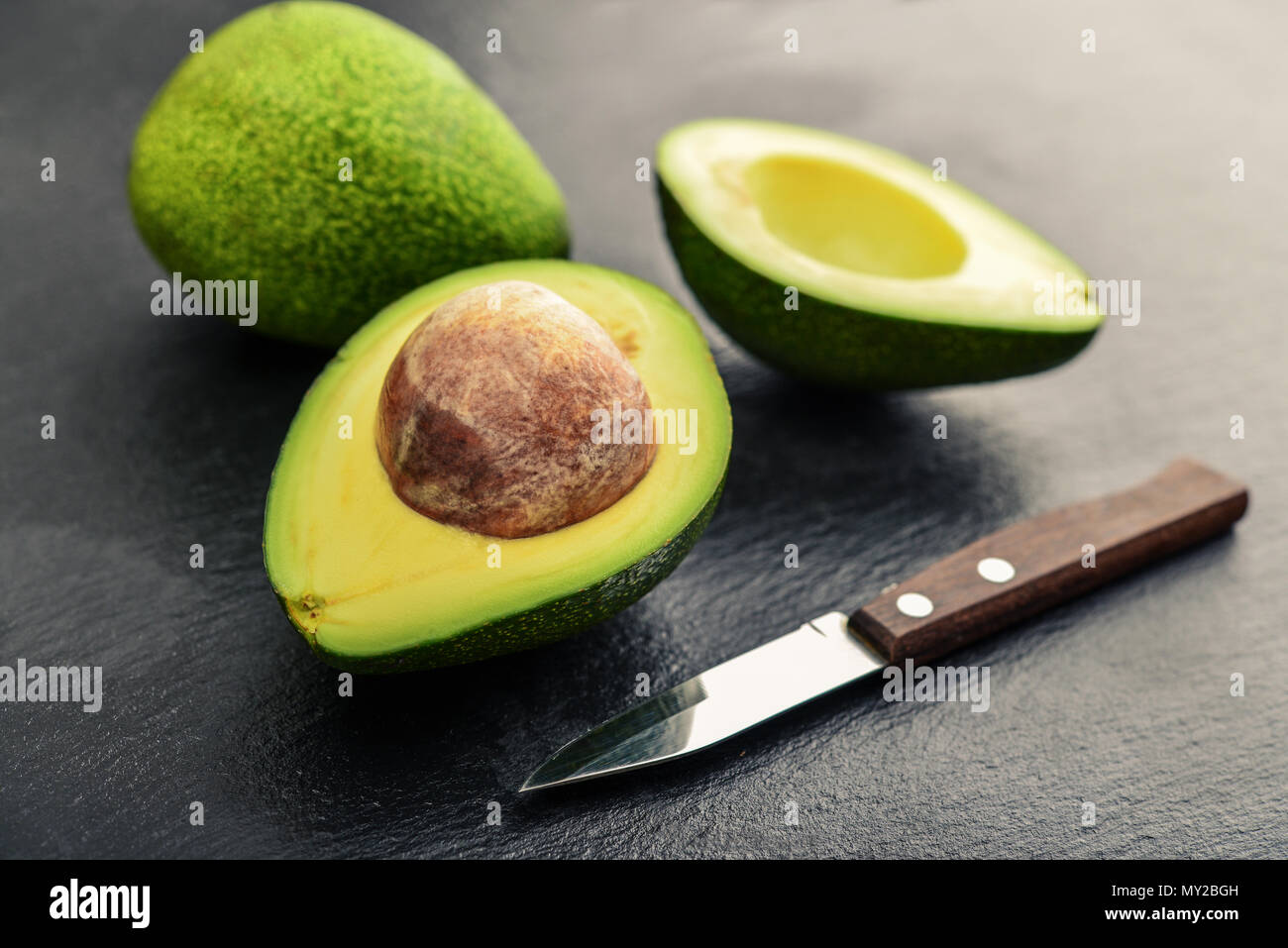 Fresh avocado  over black slate background Stock Photo