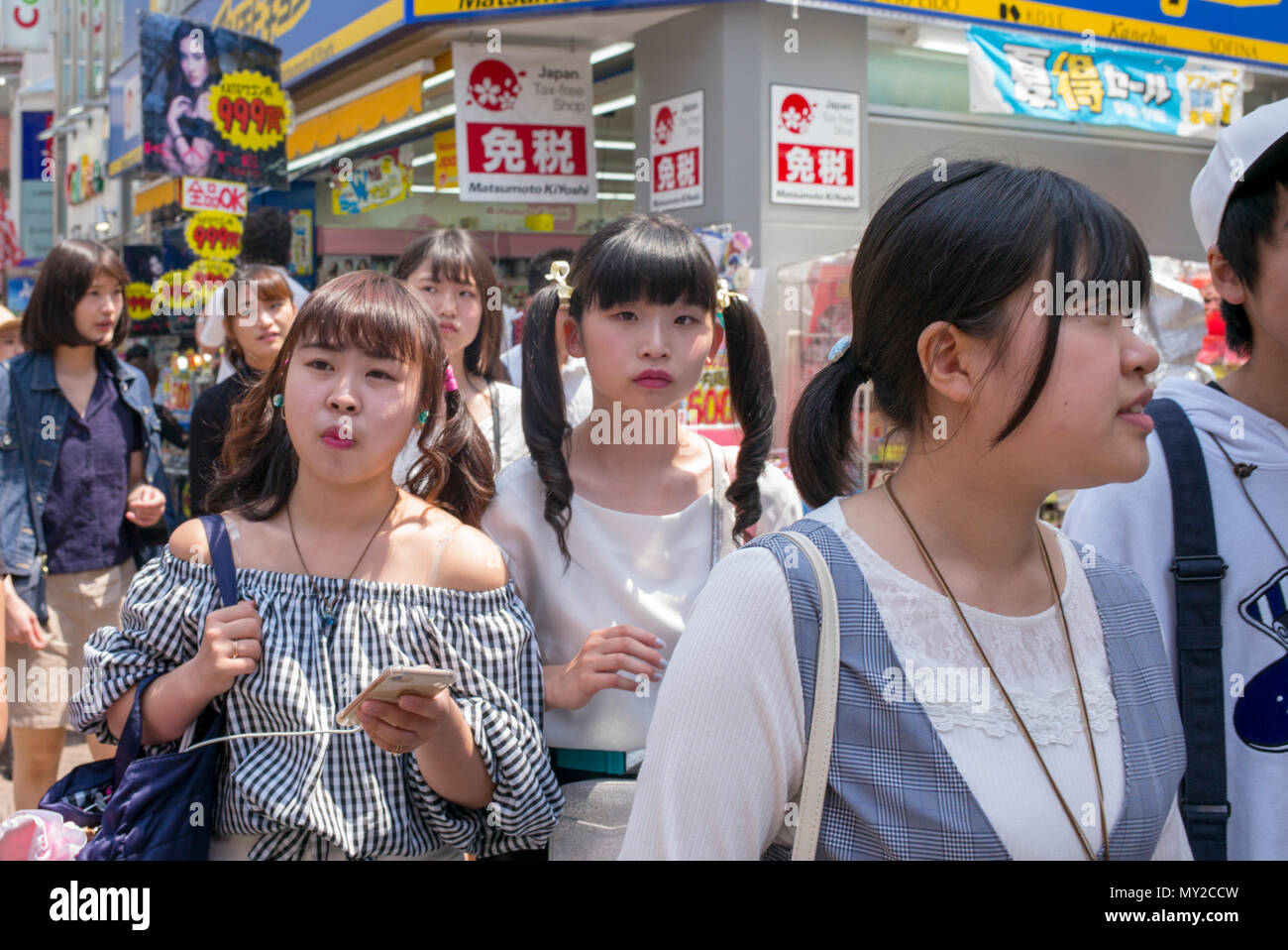 Crowds of people in Takeshita Street, a pedestrian shopping street lined with fashion boutiques, cafes and restaurants in Harajuku in Tokyo, Japan Stock Photo