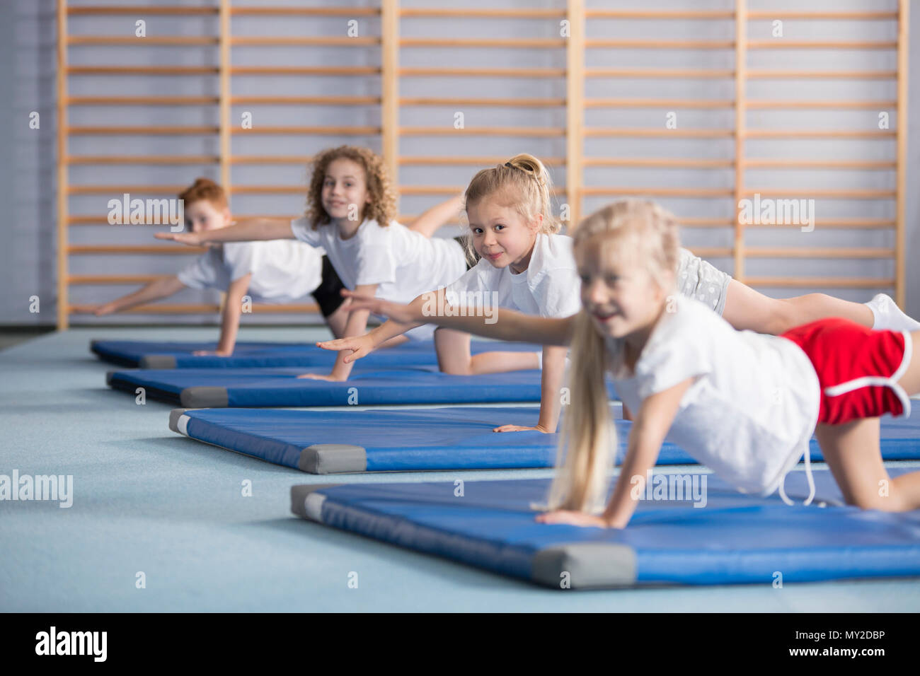 Kids performing exercises to improve their motor skills, coordination and balance Stock Photo