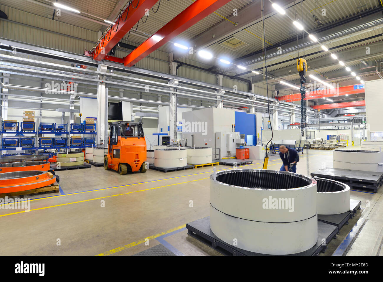 Factory of modern mechanical engineering - production of gearboxes for wind turbines - worker at cnc milling machine Stock Photo