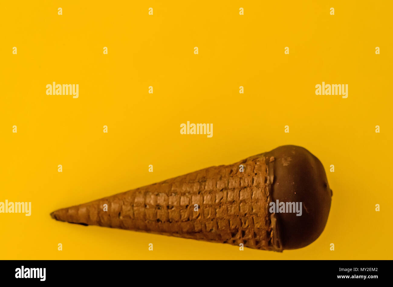 Vanilla ice cream with cranberry jam in a sugar cone dipped in chocolate on  yellow background.Pastel colour.Cool off in the hot summer.Copy space top  Stock Photo - Alamy