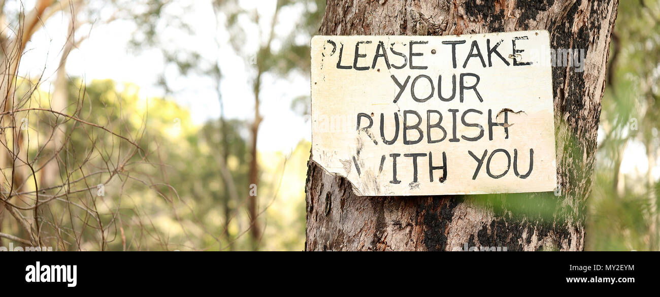 multiple views of an old worn sign post instructing campers fishermen bush walkers hikers to take responsibility for removing all waste trash rubbish  Stock Photo