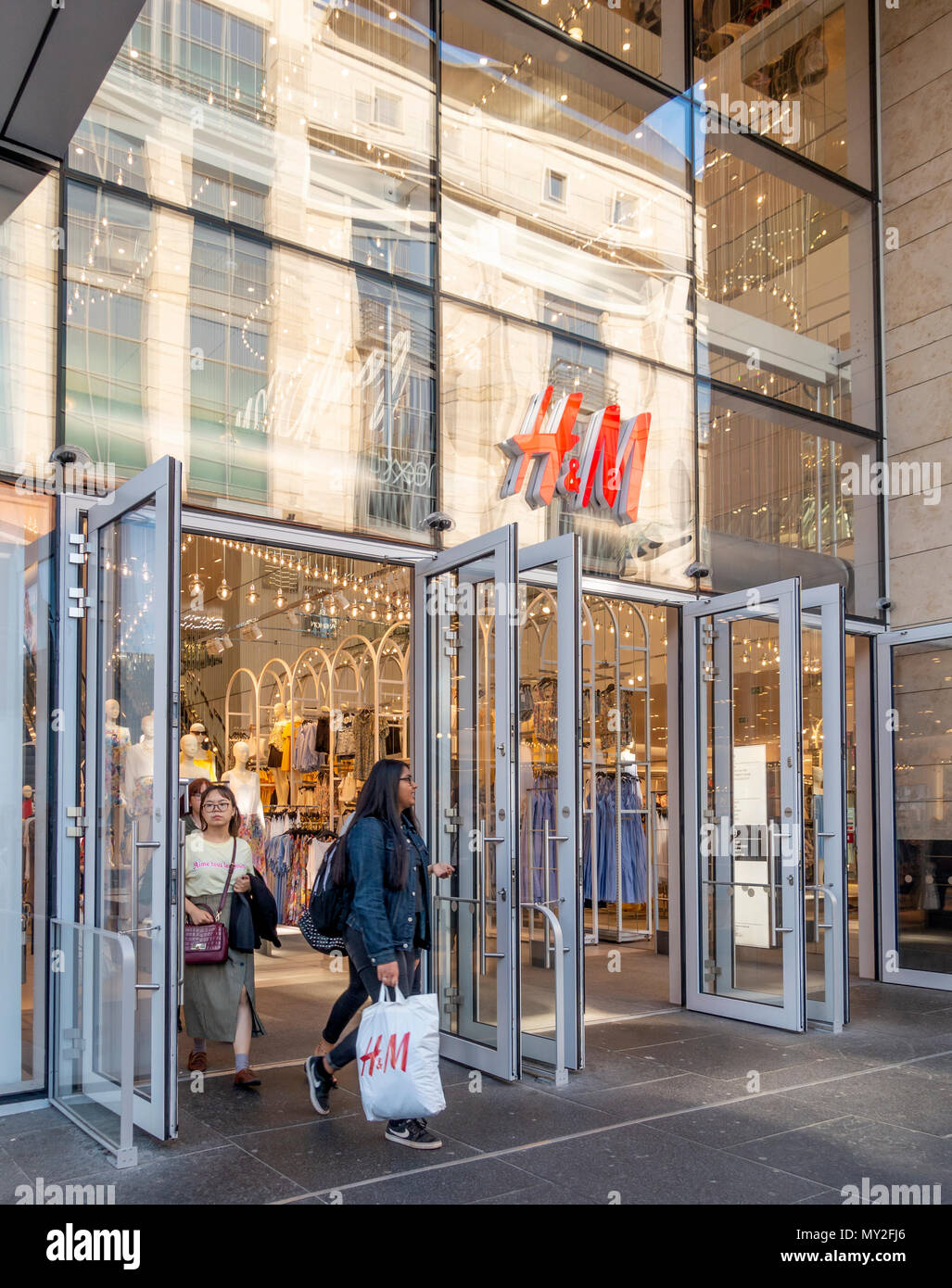 Customers leaving the H&M fashion store in Buchanan Street, Glasgow. One is  carrying an H&M carrier bag. Scotland, UK Stock Photo - Alamy