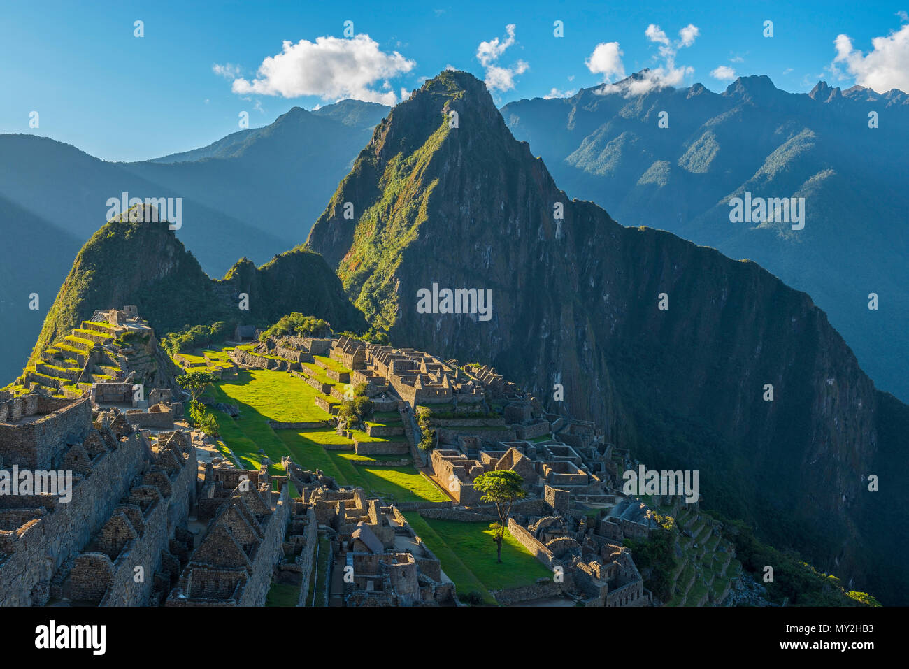 Close up of the Inca ruin of Machu Picchu at sunset with the last sun rays visible near the city of Cusco, Peru, South America. Stock Photo