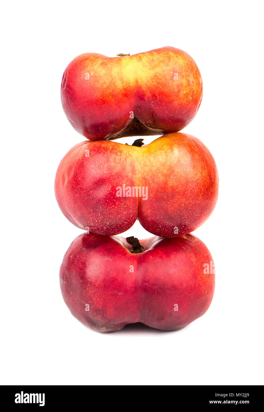 Three flat peaches piled together on a white background Stock Photo