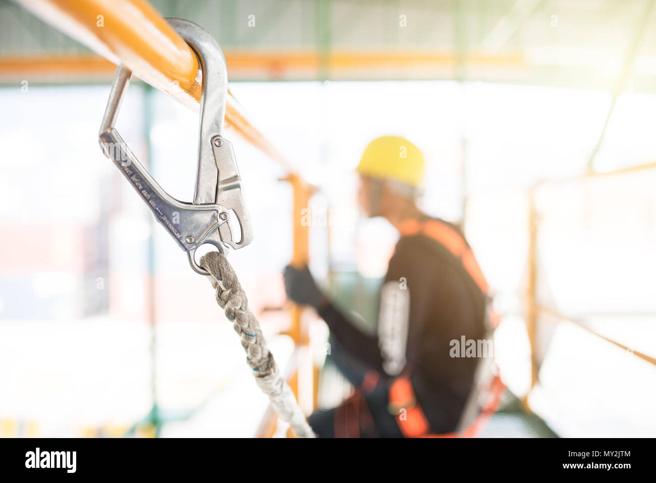 Industrial Worker with safety protective equipment loop hanging on the bar besides, safety concept Stock Photo