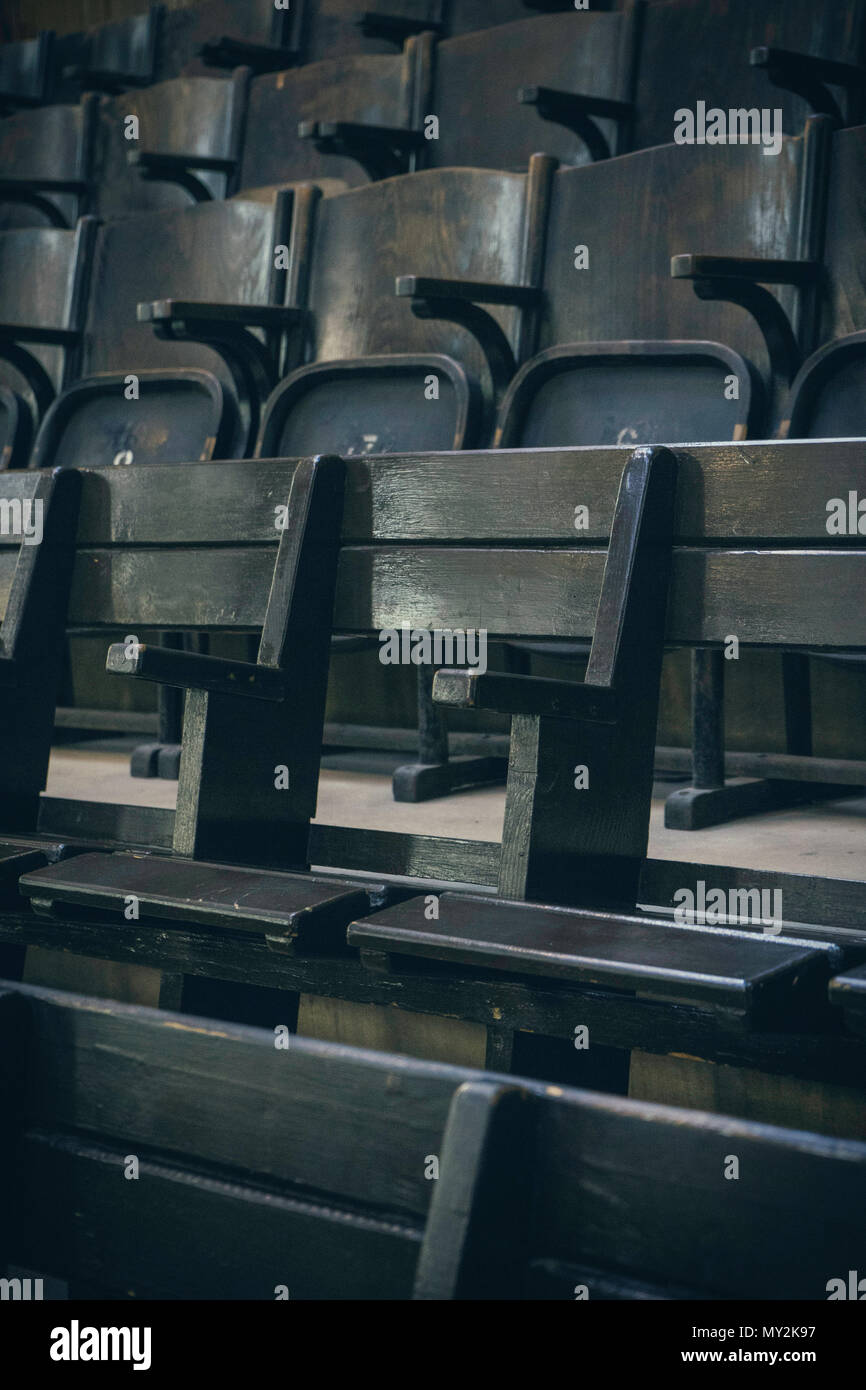 Old wooden seats in rows from a slight angle Stock Photo