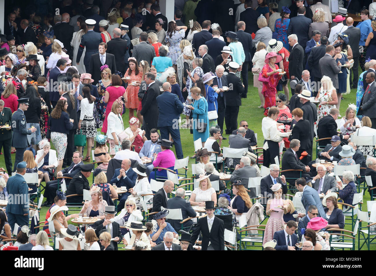 Guests attend a royal garden party at buckingham palace hires stock