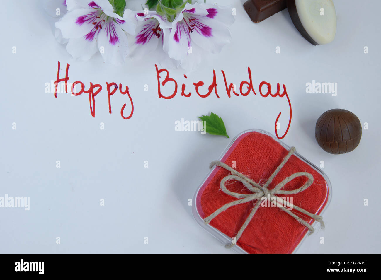 Happy Birthday Greeting Card With Gift Box Fresh Flowers And Chocolates On White Background Stock Photo Alamy