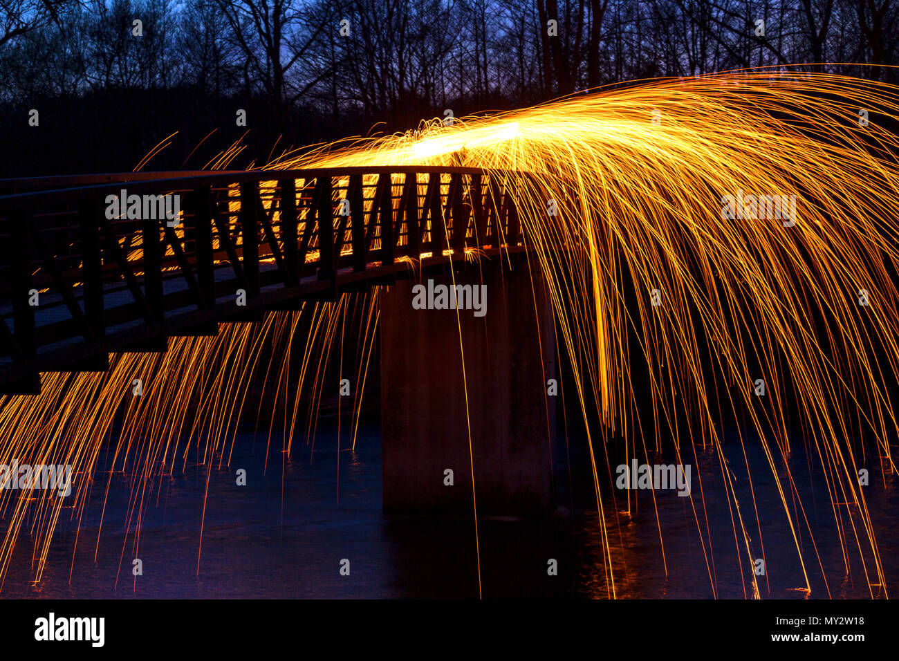 Light painting at night whirling steel wool burning at the end of a ...