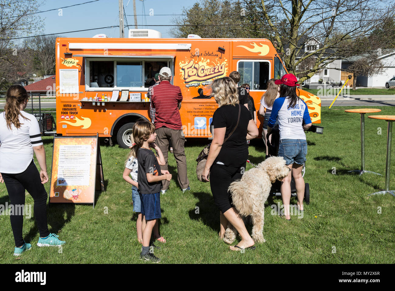 Food trucks line up on grass field Cambridge Ontario Canada Stock Photo