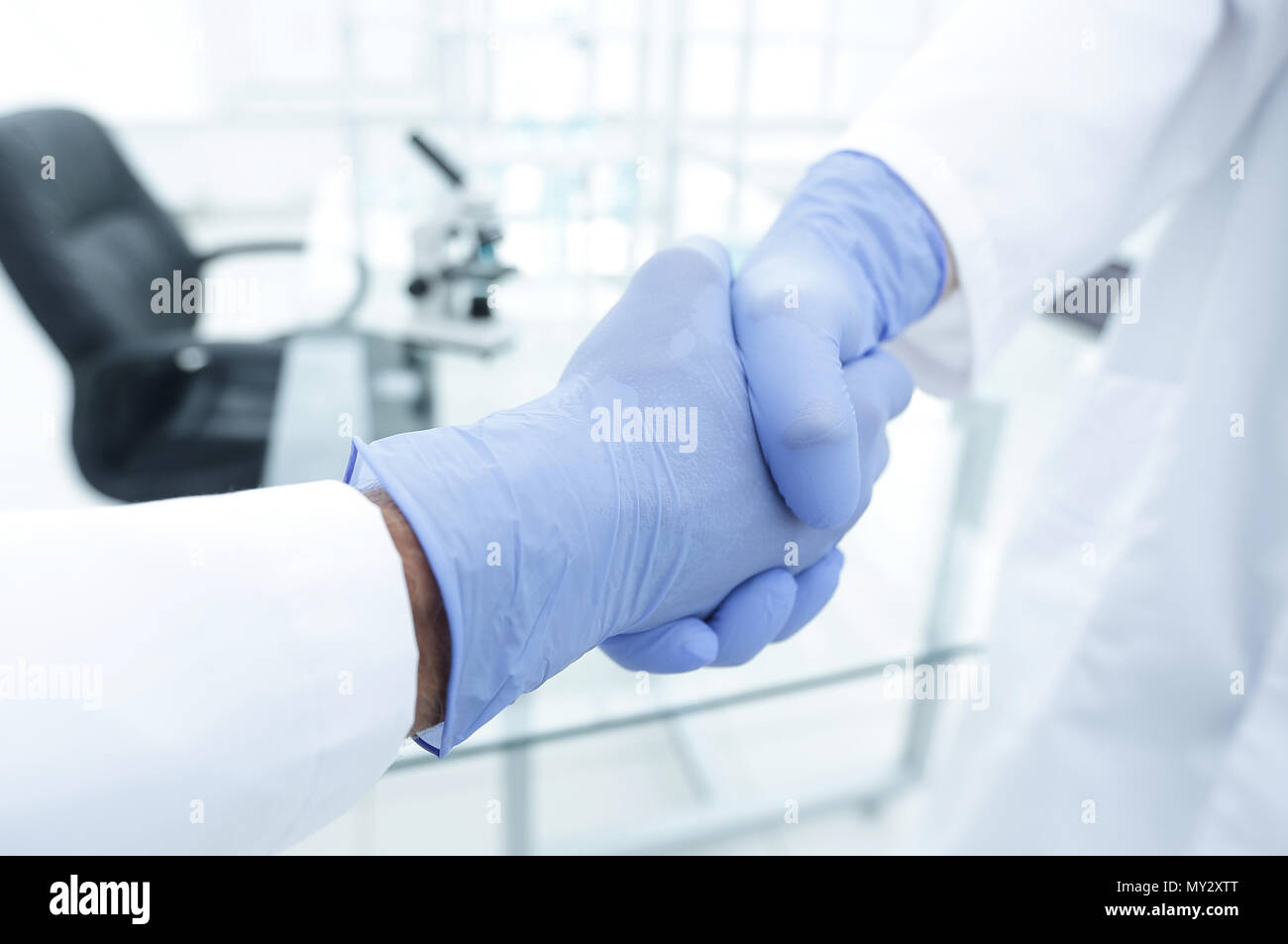 hand in the medical glove (handshake Stock Photo Alamy