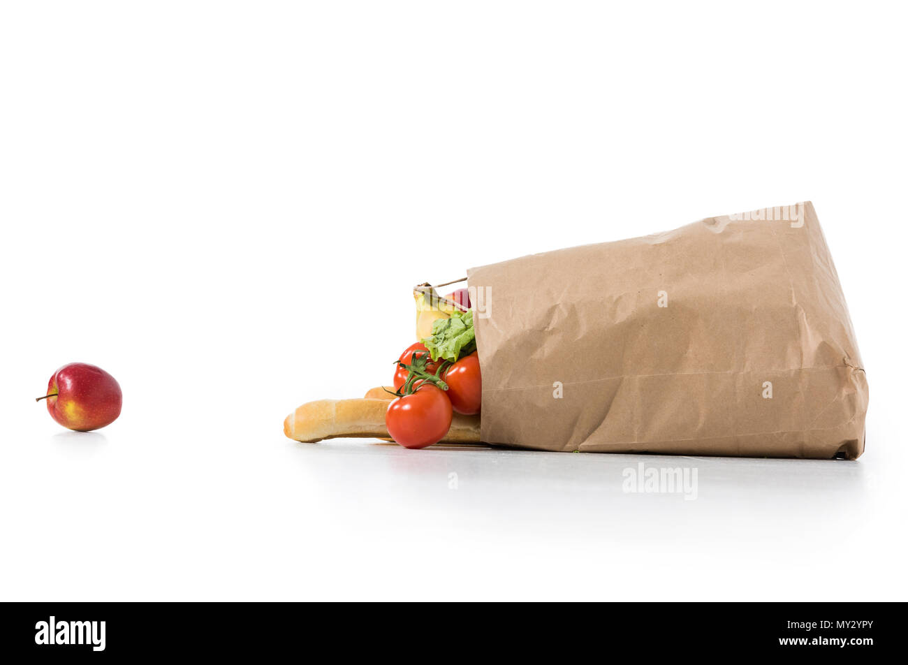 fresh ripe fruits and vegetables in brown paper bag isolated on white ...