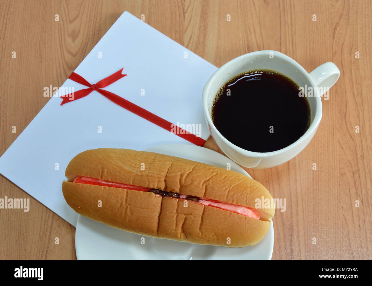 hot dog bread filled strawberry cream raisin and black coffee Stock