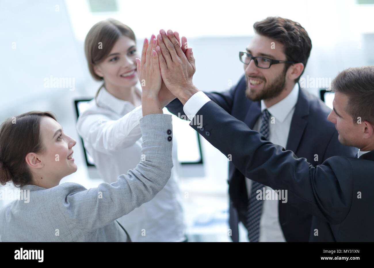 successful business team giving each other a high-five, standing in the ...