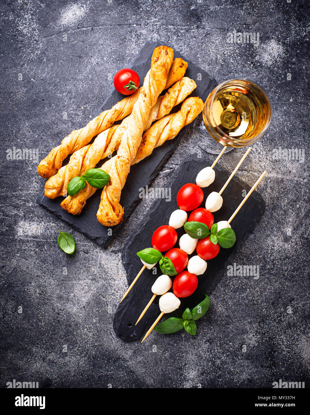 Traditional Italian antipasto caprese skewers and grissini bread Stock