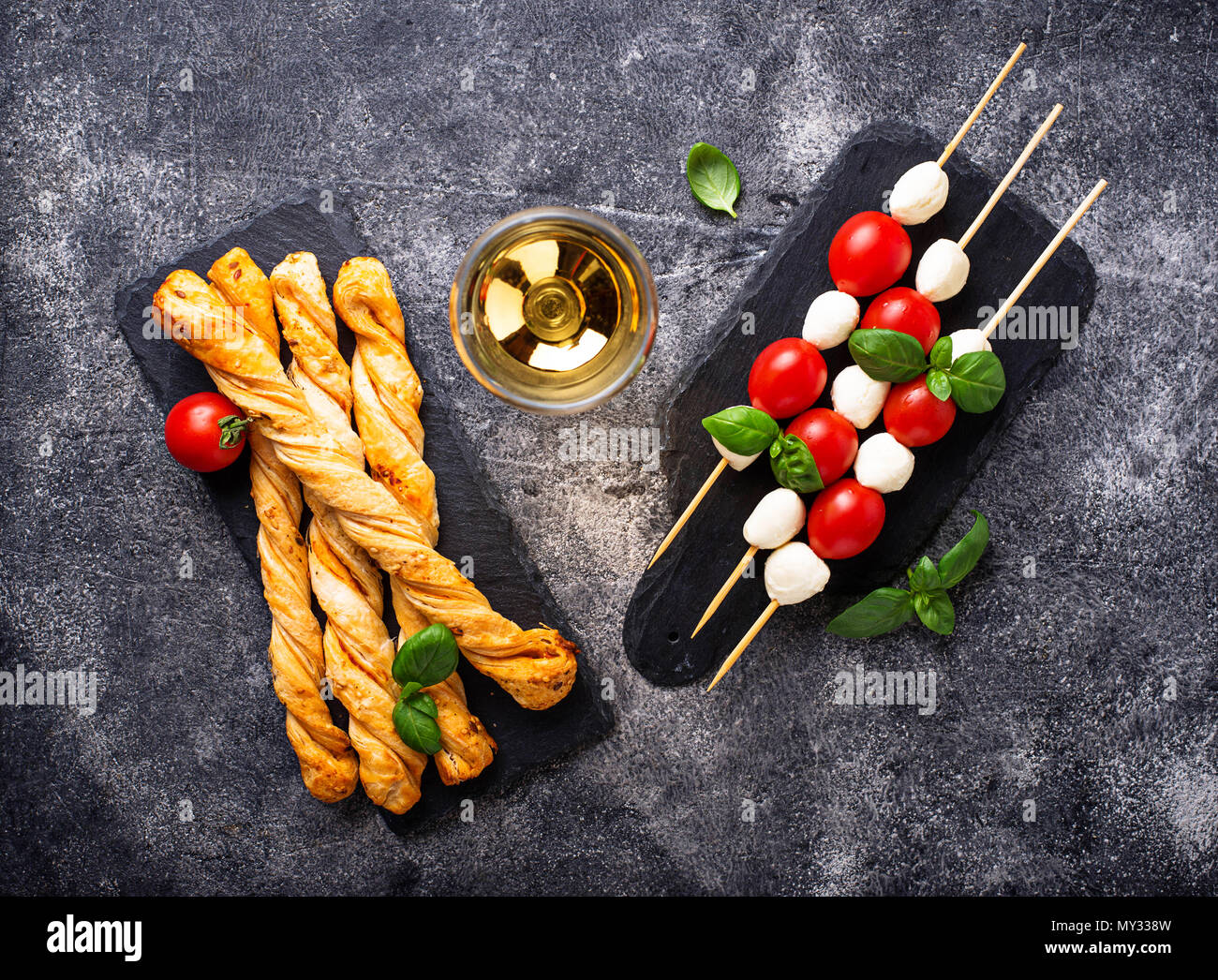 Traditional Italian antipasto caprese skewers and grissini bread Stock