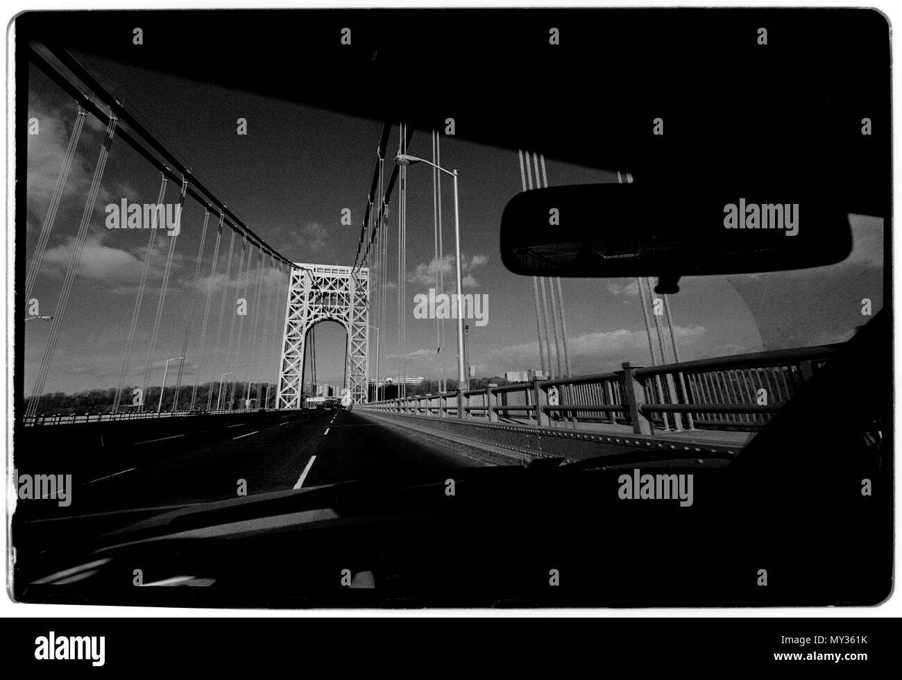 New York City USA 1988 George Washington Bridge The George Washington Bridge – known informally as the GW Bridge – is a double-decked suspension bridge spanning the Hudson River between the Washington Heights neighborhood of Manhattan in New York City and Fort Lee, New Jersey. As of 2016, the George Washington Bridge carried over 103 million vehicles per year,[8] making it the world's busiest motor vehicle bridge. It is owned by the Port Authority of New York and New Jersey, a bi-state government agency that operates infrastructure in the Port of New York area.  A bridge across the Hudson Rive Stock Photo