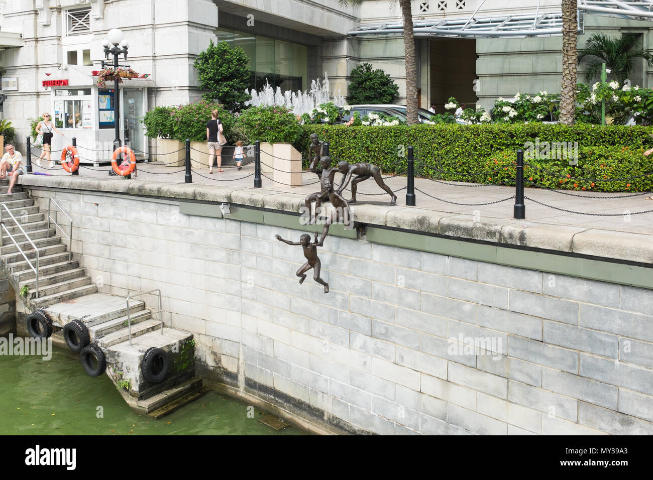 The First Generation sculpture by Chong Far Cheong on the bank of the Singapore River at Fullerton Square also known as the 'Jumping Boys' sculpture Stock Photo