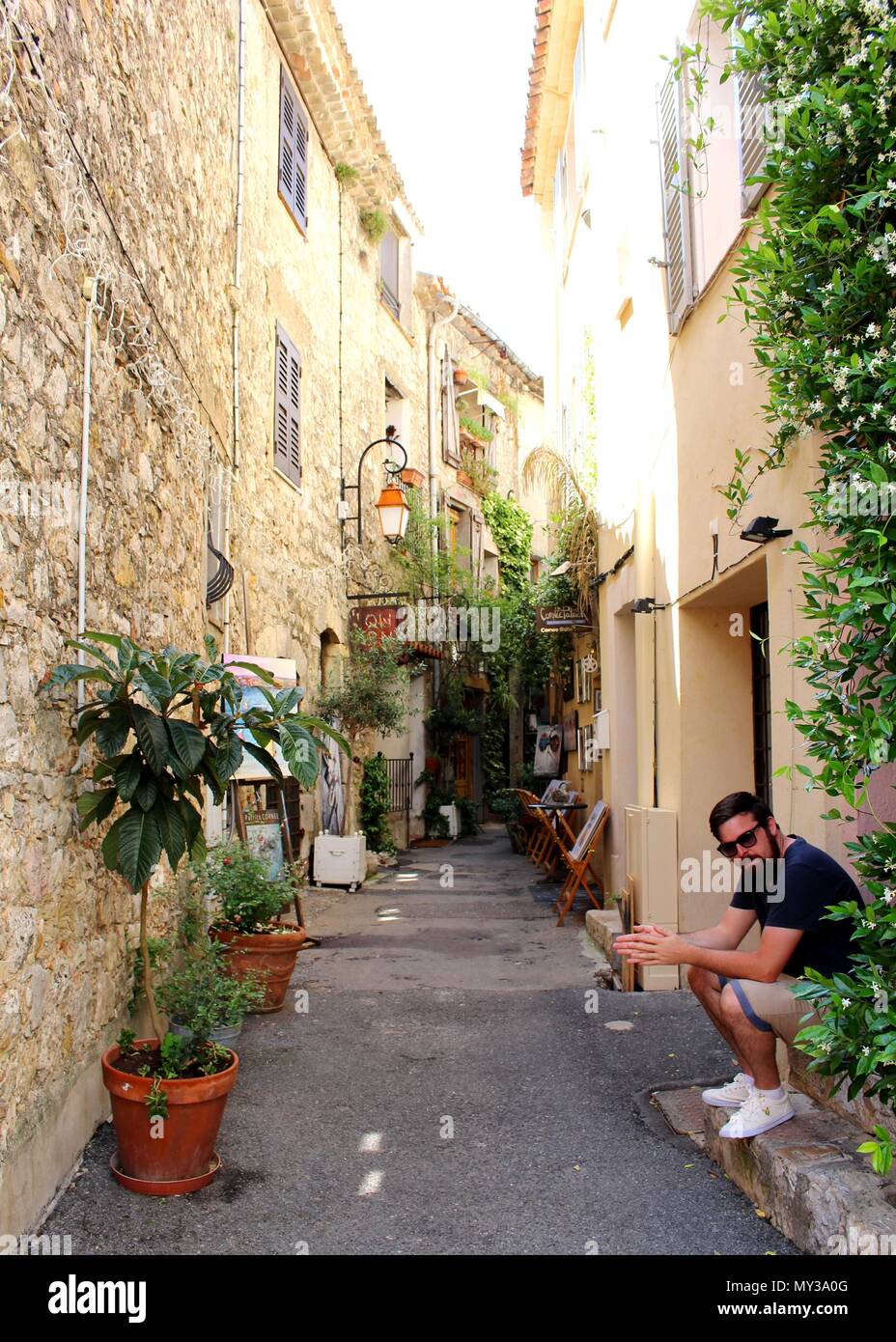 A tourist takes a rest after exploring the artist village of Mougins. Stock Photo