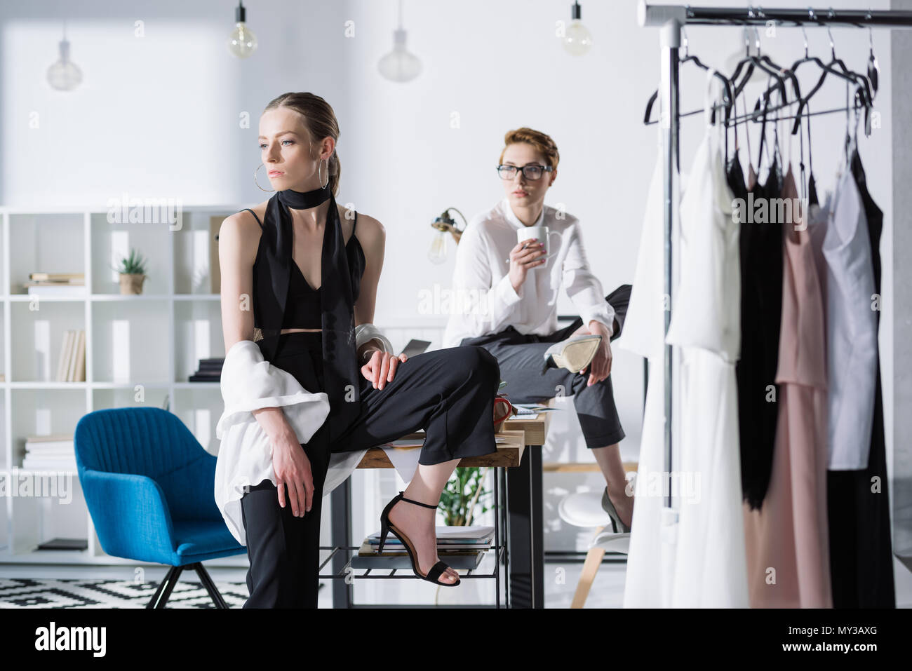 stylish young fashion designers sitting on work desk at office Stock ...