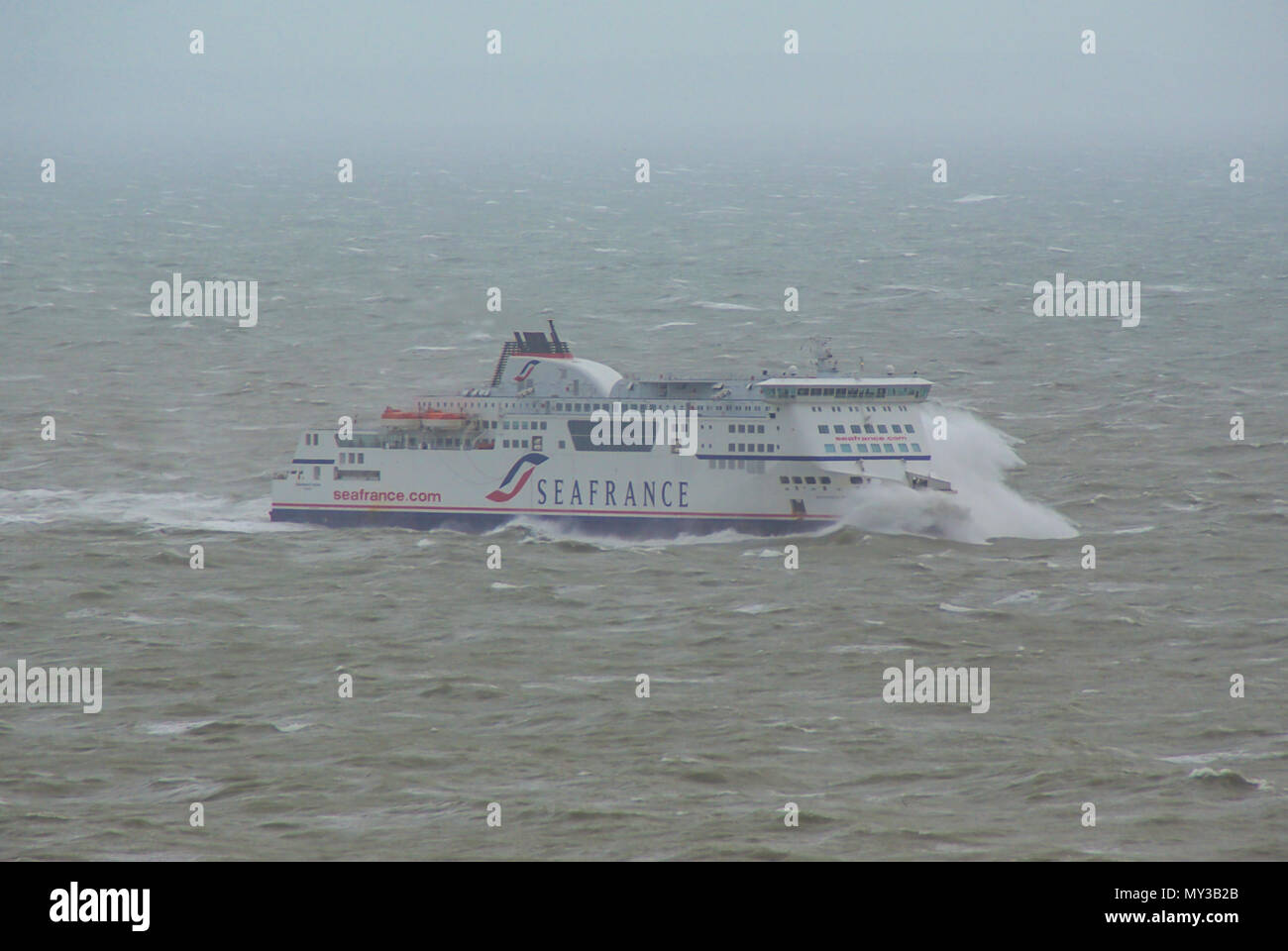 Sea France cross channel ferry struggling in bad weather in English Channel. Waves crashing over the front. Heavy swell approaching Dover, Kent, UK Stock Photo